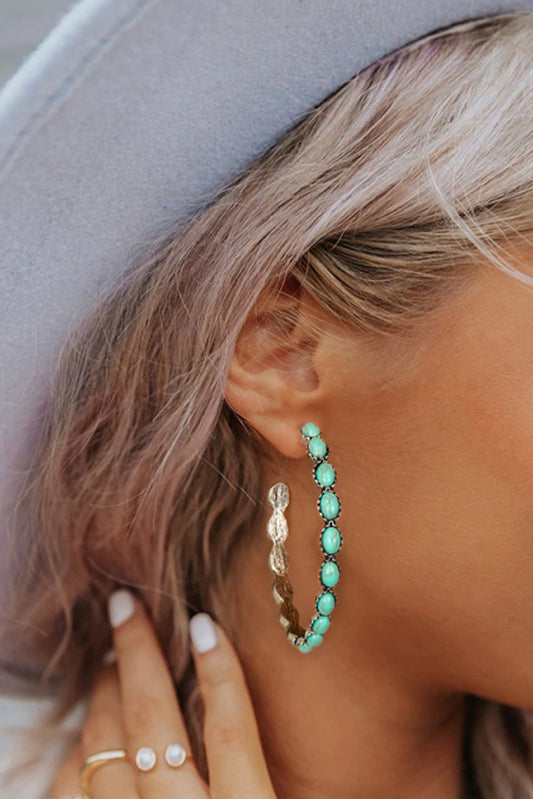 Vintage vibes, modern sparkle. These retro-inspired C-shape earrings are a dreamy blend of bold design and delicate detail. Featuring a smooth gold-tone curve inlaid with sky blue gems, they catch the light—and compliments—with every turn of your head.