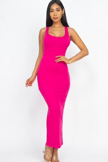 Woman wearing a bright pink sleeveless dress on a white background