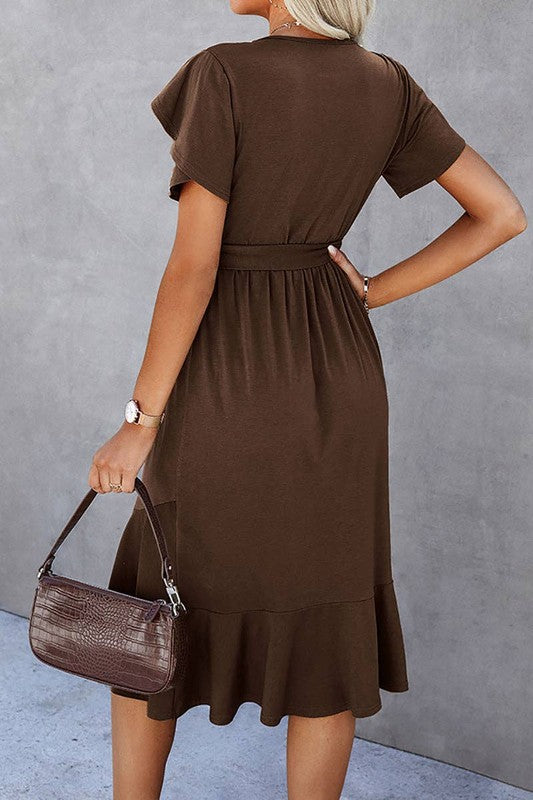 Woman wearing a petal sleeve wrap midi dress with ruffle trim and belted waist