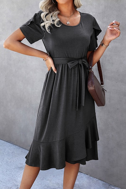Woman wearing a petal sleeve wrap midi dress with ruffle trim and belted waist