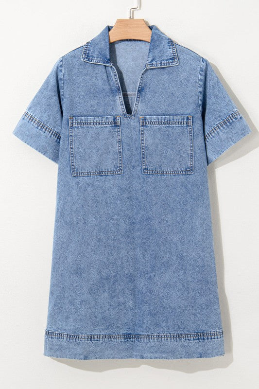 a short-sleeved, collared denim mini dress in faded blue wash, featuring a V-neckline, front patch pockets