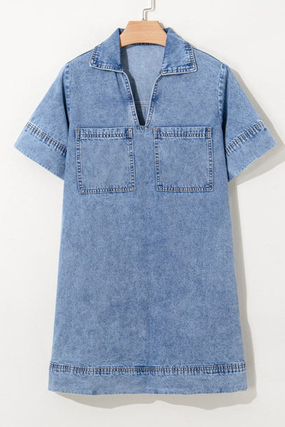 a short-sleeved, collared denim mini dress in faded blue wash, featuring a V-neckline, front patch pockets