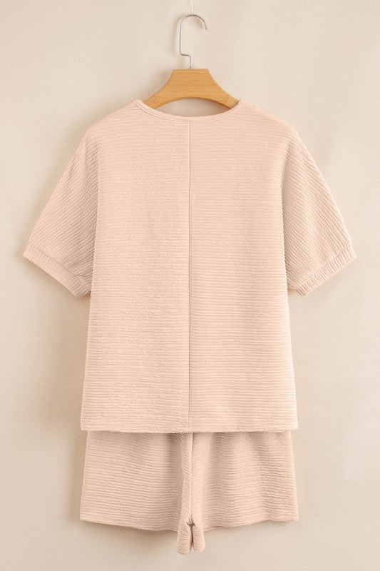 Effortless style. Everyday comfort. This two-piece set combines a textured tee and matching shorts for a laid-back look that’s anything but basic. Whether you're lounging at home or heading out for errands, this set keeps you cool, coordinated, and confident.