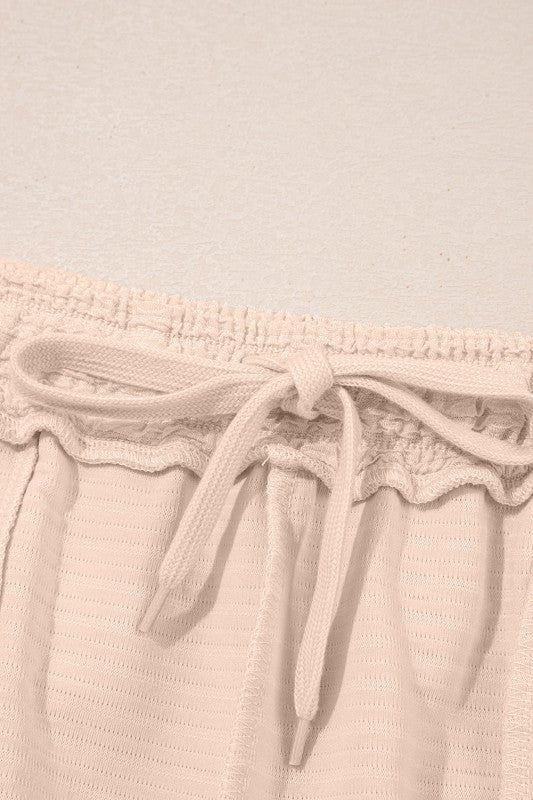 Effortless style. Everyday comfort. This two-piece set combines a textured tee and matching shorts for a laid-back look that’s anything but basic. Whether you're lounging at home or heading out for errands, this set keeps you cool, coordinated, and confident.