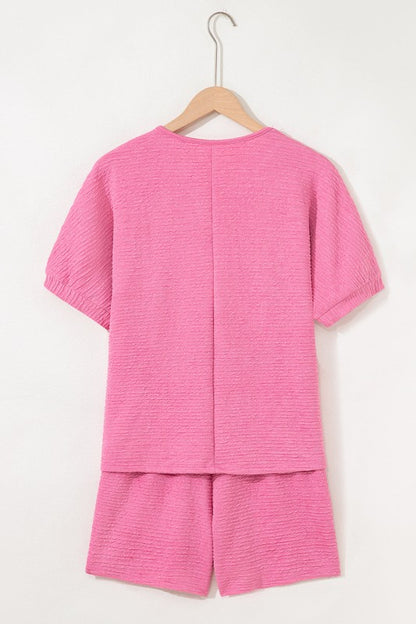 Effortless style. Everyday comfort. This two-piece set combines a textured tee and matching shorts for a laid-back look that’s anything but basic. Whether you're lounging at home or heading out for errands, this set keeps you cool, coordinated, and confident.