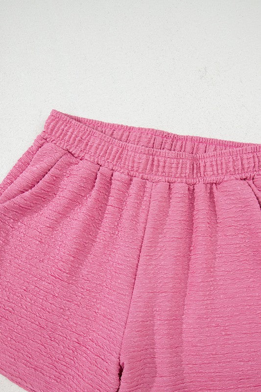 Effortless style. Everyday comfort. This two-piece set combines a textured tee and matching shorts for a laid-back look that’s anything but basic. Whether you're lounging at home or heading out for errands, this set keeps you cool, coordinated, and confident.