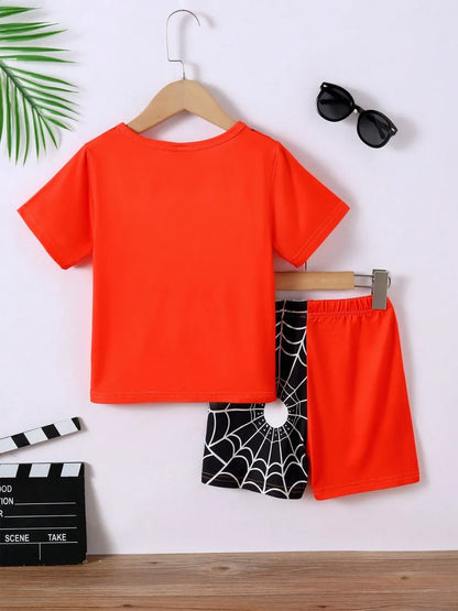 Orange t-shirt and shorts with black spider web design on a white background