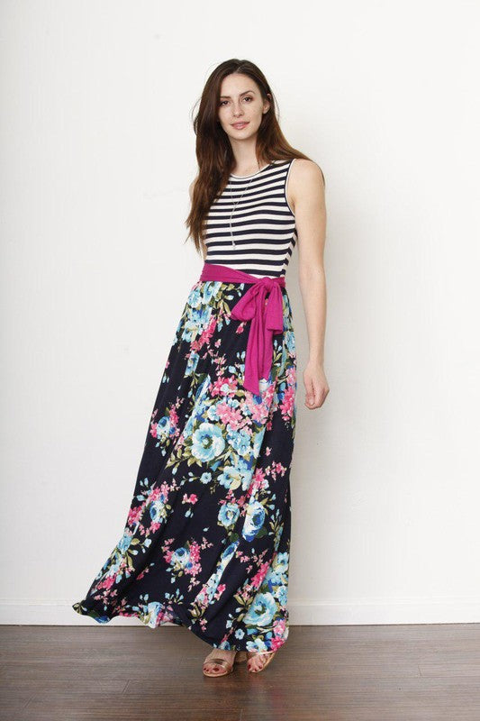 A girl in the pic is rocking a black-and-white striped sleeveless top paired with a flowy maxi skirt.