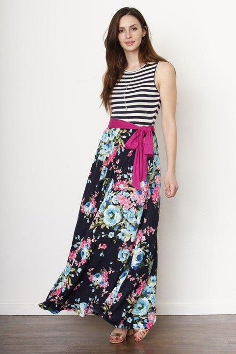  A girl in the pic is rocking a black-and-white striped sleeveless top paired with a flowy maxi skirt.