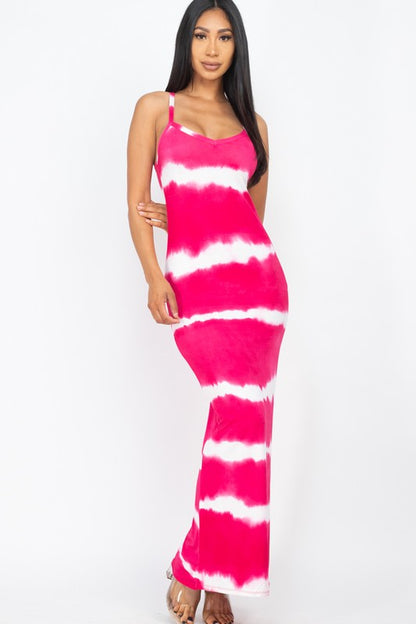 Woman wearing a sleeveless pink and white tie-dye maxi dress with spaghetti straps, paired with white sneakers.”