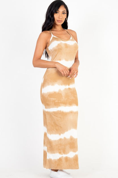 Woman wearing a sleeveless brown and white tie-dye maxi dress.