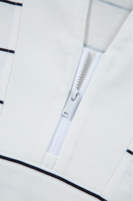 V-neckline with zipper detail adds a modern touch.