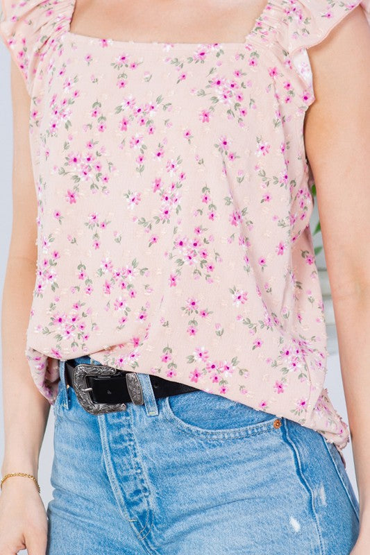 Romantic detailing with Swiss dots and cascading ruffle sleeves.