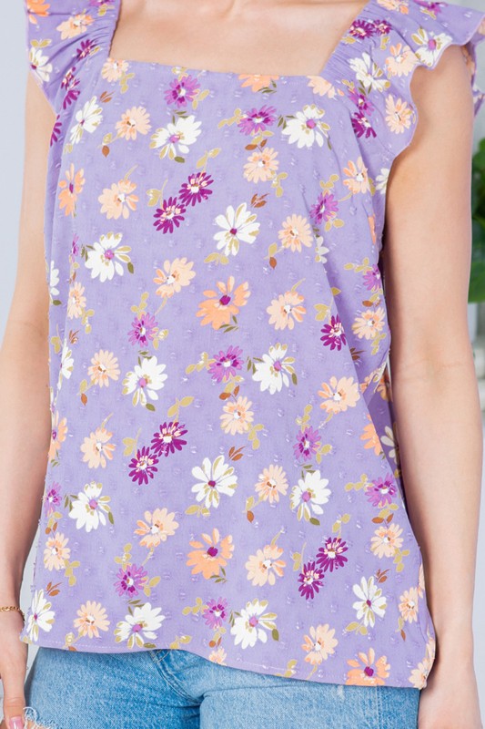 Add dimension and grace to your look with dotted texture and flutter sleeves.