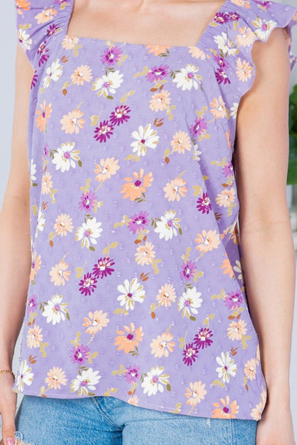 Add dimension and grace to your look with dotted texture and flutter sleeves.