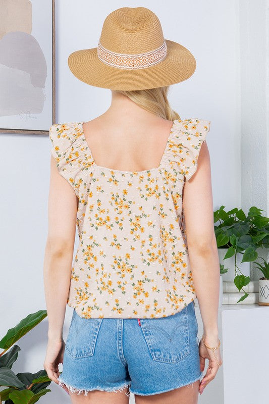 Swiss-dot details and flutter sleeves create a refined yet playful top.