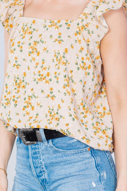 Dress it up or down — this Swiss-dot, ruffle-sleeve top blends texture and elegance.