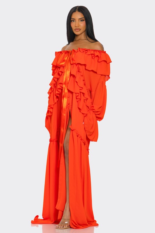 A vibrant off-the-shoulder gown in bright orange with dramatic ruffles cascading down the bodice and a high thigh-high slit on one side