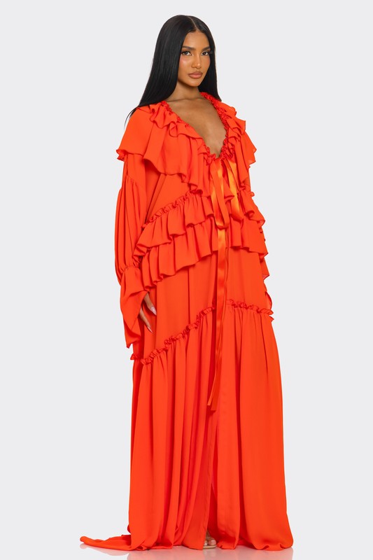 A vibrant off-the-shoulder gown in bright orange with dramatic ruffles cascading down the bodice and a high thigh-high slit on one side