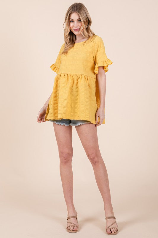 Relaxed silhouette meets decorative ruffles for effortless charm.