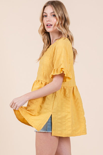 Side slits and ruffle sleeves elevate this tunic beyond basic.
