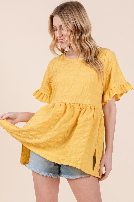 A tunic with textured fabric and fluttery ruffle sleeves for a soft, stylish touch.