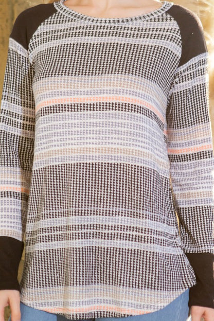 A refined knit piece that combines texture and stripe design for understated elegance.