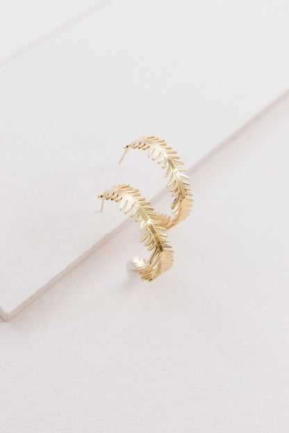 These Leaf Wreath Hoop Earrings feature a delicate arrangement of leaves—some adorned with shimmering crystals—forming a graceful wreath around your earlobe. Whether you’re dressing for brunch, a garden party, or a romantic evening, these hoops bring a touch of organic beauty to any look.