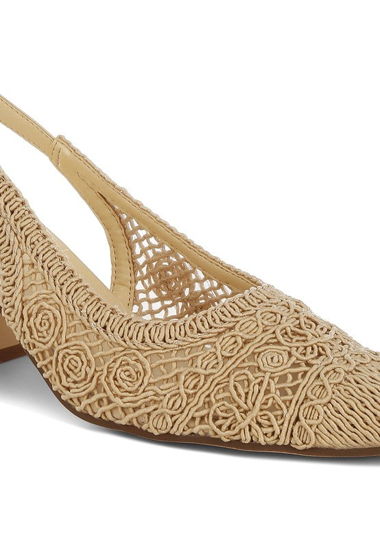 a stylish women's shoe with a closed, almond toe and an intricate lace-like upper in a light beige color.