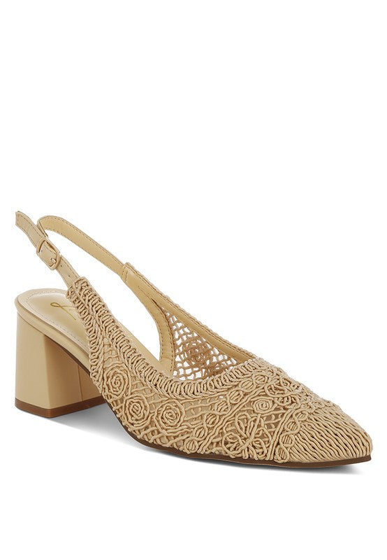 a stylish women's shoe with a closed, almond toe and an intricate lace-like upper in a light beige color.
