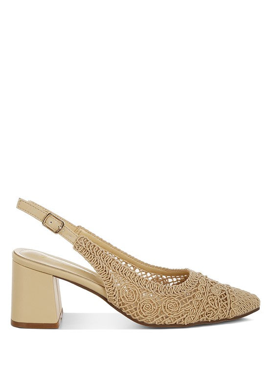 a stylish women's shoe with a closed, almond toe and an intricate lace-like upper in a light beige color.