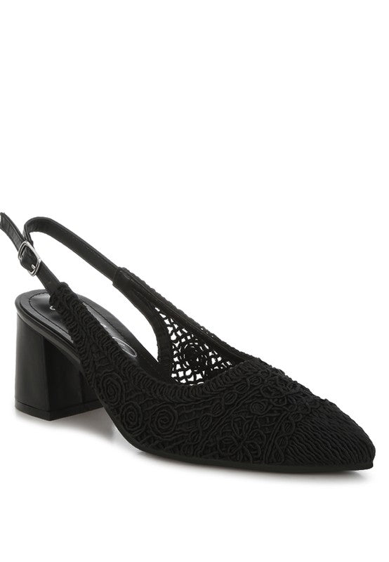 a black stylish women's shoe with a closed, almond toe and an intricate lace-like upper in a light beige color.