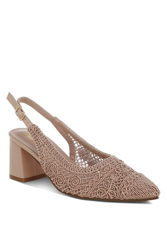 a stylish women's shoe with a closed, almond toe and an intricate lace-like upper in a light beige color.