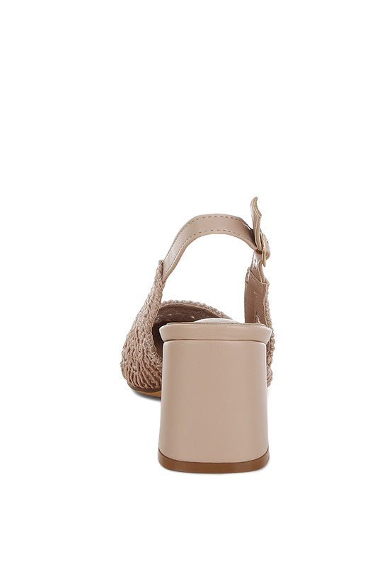 a stylish women's shoe with a closed, almond toe and an intricate lace-like upper in a light beige color.