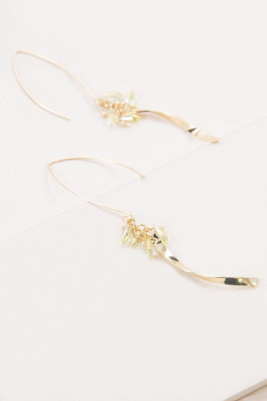 These Twist Arc Threader Earrings in Lemon feature a graceful gold arc that threads effortlessly through the ear, accented with iridescent lemon-hued stones that catch the light with every move. Whether you're headed to brunch or a sunset soirée, these earrings bring effortless elegance with a playful twist.