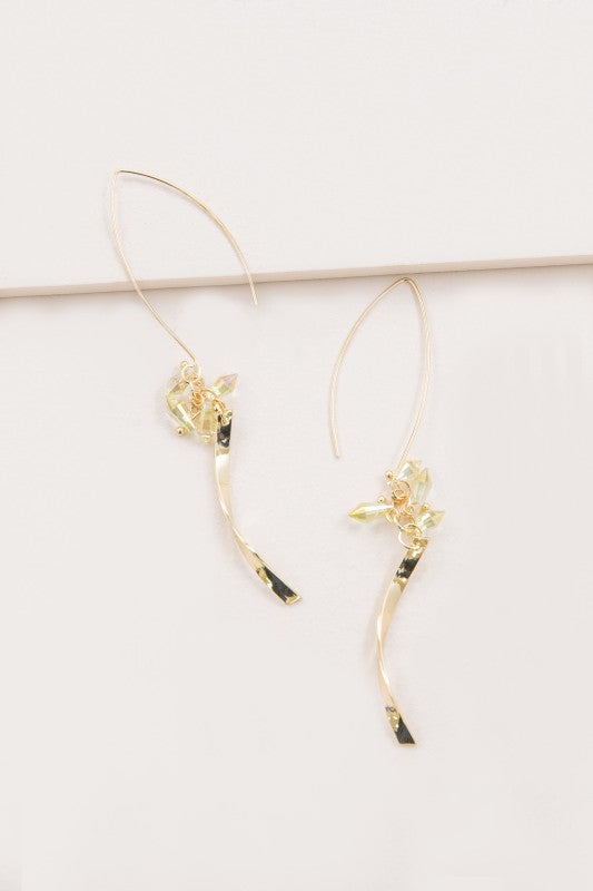 These Twist Arc Threader Earrings in Lemon feature a graceful gold arc that threads effortlessly through the ear, accented with iridescent lemon-hued stones that catch the light with every move. Whether you're headed to brunch or a sunset soirée, these earrings bring effortless elegance with a playful twist.