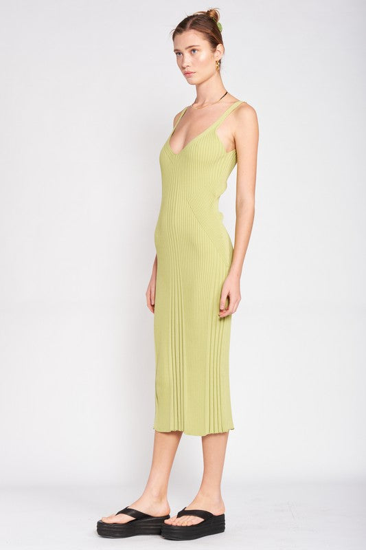 Woman wearing a light green pleated dress on a white background