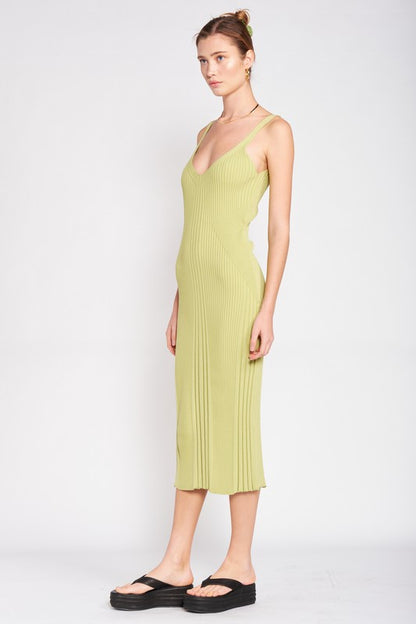 Woman wearing a light green pleated dress on a white background