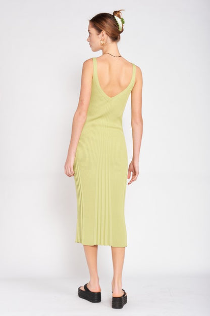 Woman wearing a light green dress with a backless design on a white background