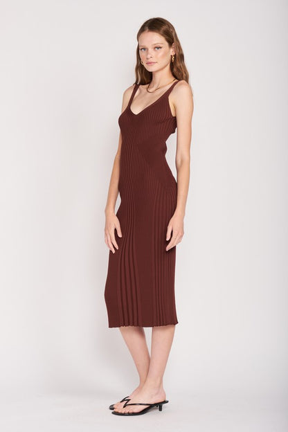model wearing a brown ribbed dress on a white background