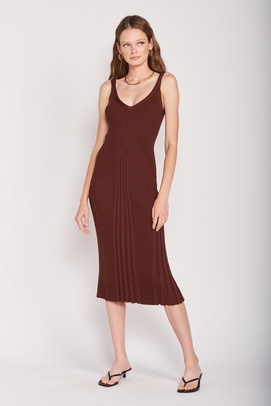 Woman wearing a brown ribbed dress on a white background