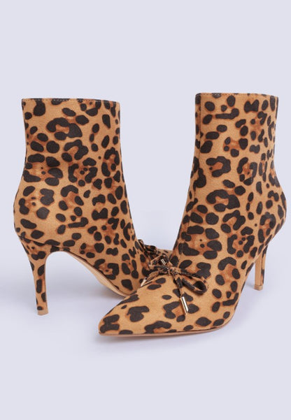 Leopard print ankle boots with a gold bow on a white background