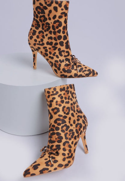 Leopard print high-heeled boots on a light gray background