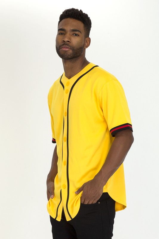 Man wearing a baseball-style shirt with black piping, yellow buttons, and red-striped short sleeves.