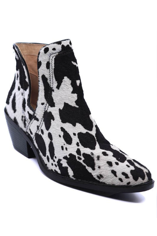 Western ankle booties featuring cow print hair-on-hide texture, pointed toe, chunky stacked heel, and side zip entry