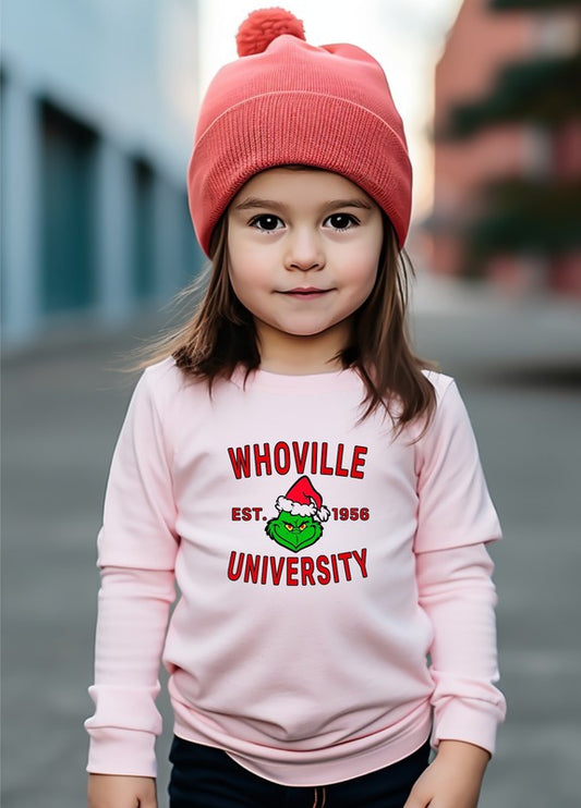 Child wearing a pink 'Whoville University' sweatshirt with a red beanie.