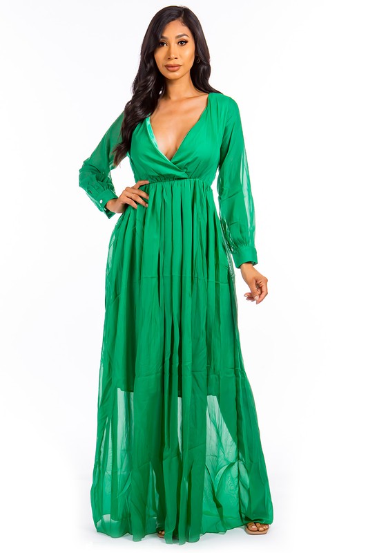 This sexy maxi dress features a form-fitting silhouette, a daring plunge neckline, and a flowing floor-length skirt that elongates the figure while adding a sultry, glamorous vibe.