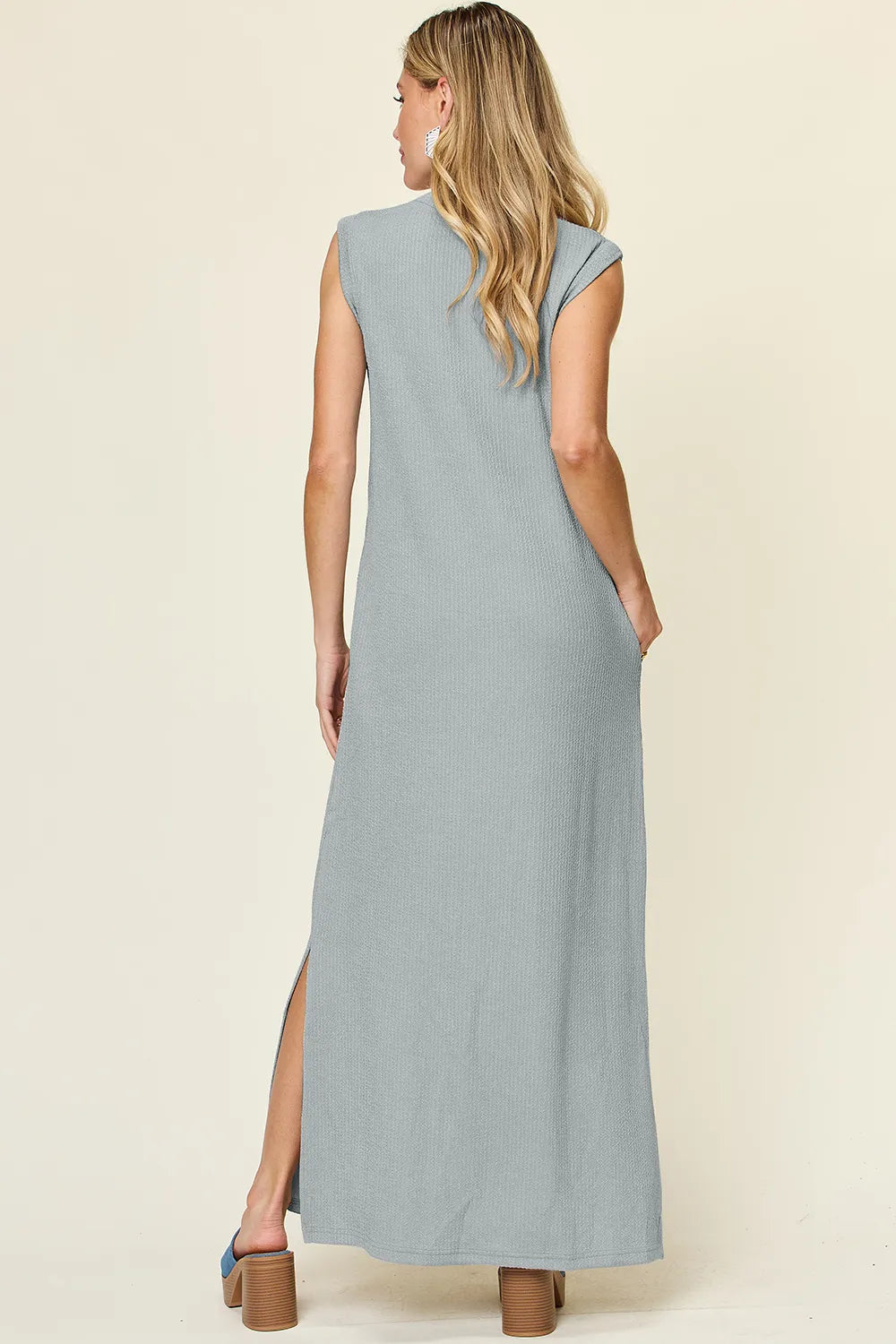 The Double Take full-size texture mock-neck sleeveless maxi dress features a sleek, textured fabric with a refined mock neckline and a flowing, floor-length silhouette for elegant, all-day wear.

