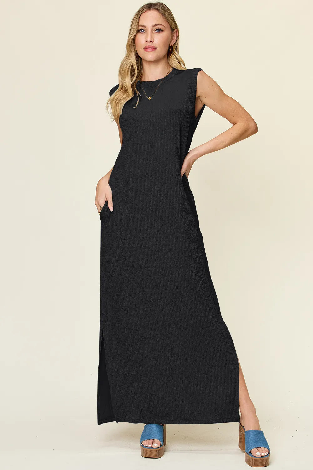The Double Take full-size texture mock-neck sleeveless maxi dress features a sleek, textured fabric with a refined mock neckline and a flowing, floor-length silhouette for elegant, all-day wear.

