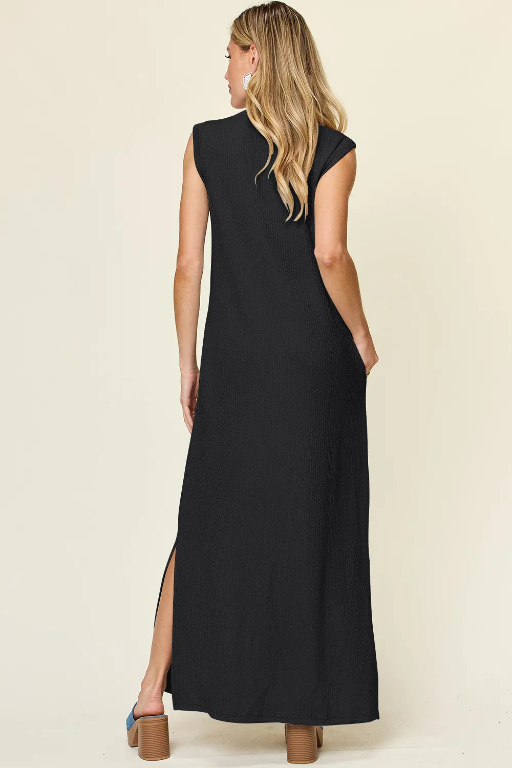The Double Take full-size texture mock-neck sleeveless maxi dress features a sleek, textured fabric with a refined mock neckline and a flowing, floor-length silhouette for elegant, all-day wear.

